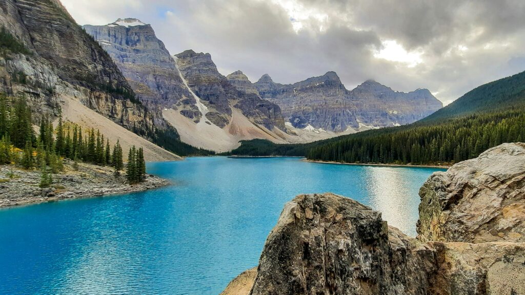 Moraine Lake with mountains and forest in Banff National Park, representing Canada work visa opportunities 2025–2026.